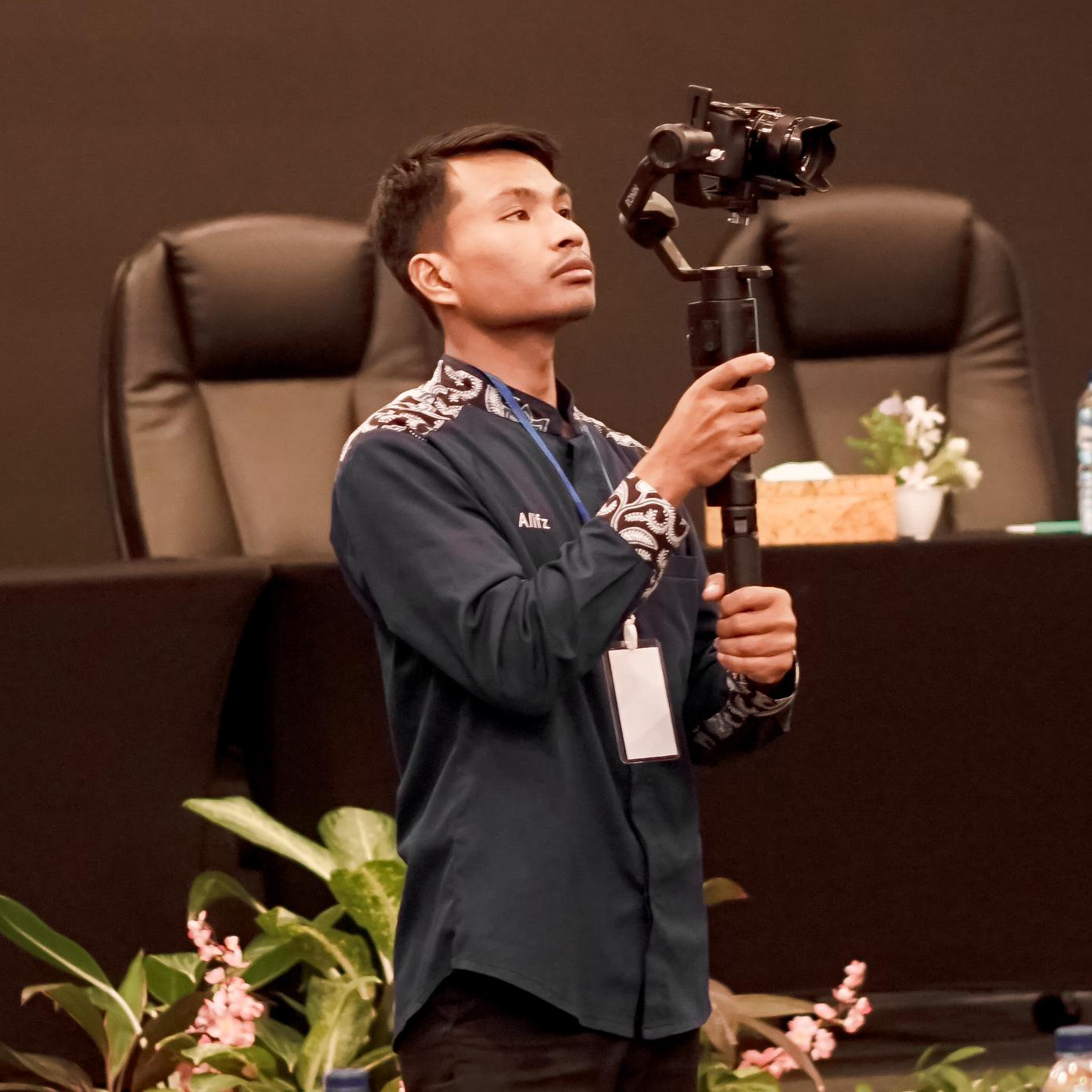 Corporate photo of startup CEO Dewi Lestari in business casual attire standing confidently